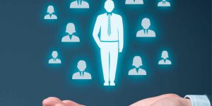 man holding hand up with picture of business people high performance leaders